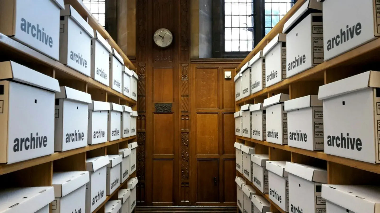 Archive shelves lined with storage boxes in a formal records room